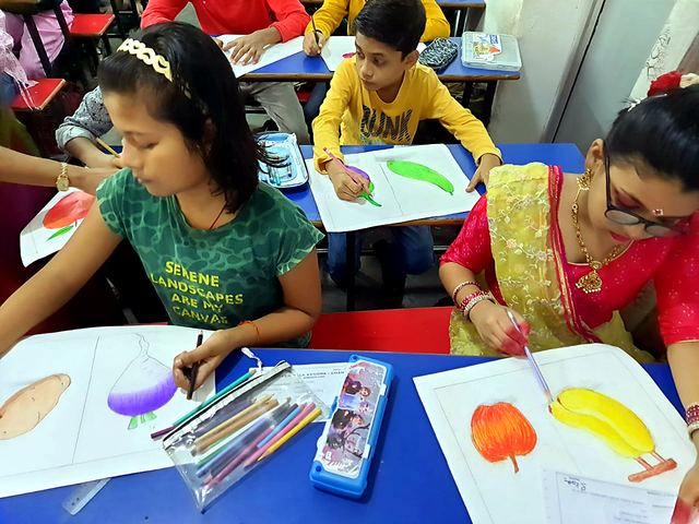 Young children mixing colours and painting in class