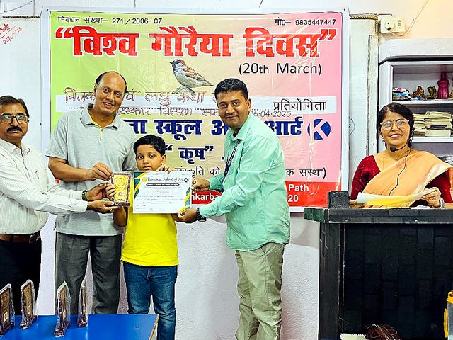 Guests presenting a certificate to a child at a programme